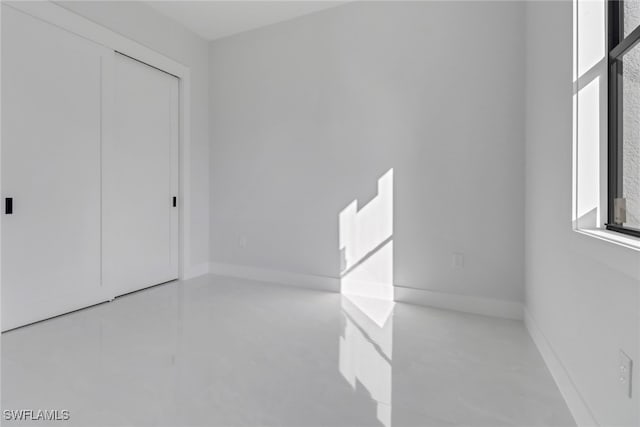 unfurnished bedroom featuring multiple windows