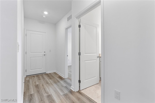 hall with light hardwood / wood-style flooring