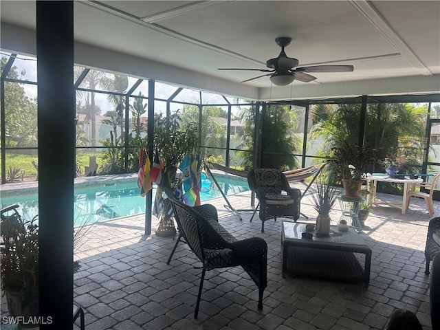 view of swimming pool featuring a lanai, a patio area, and ceiling fan