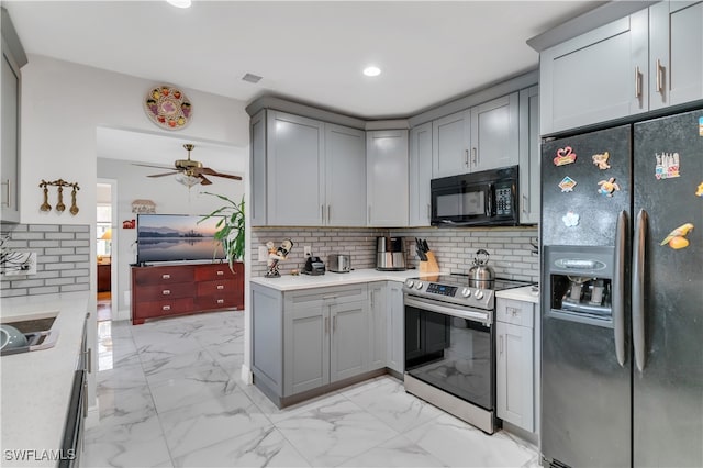 kitchen with tasteful backsplash, ceiling fan, gray cabinetry, and black appliances