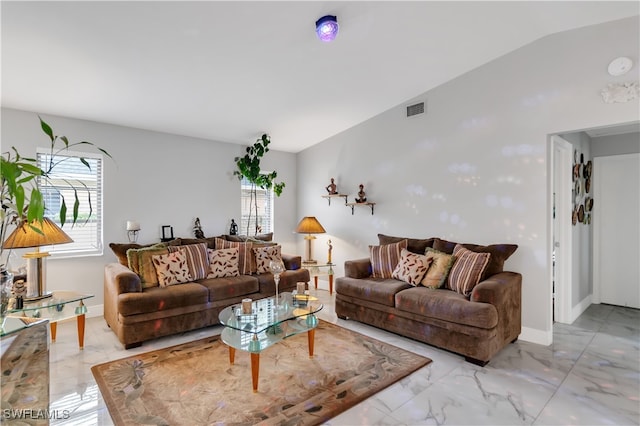 living room with a wealth of natural light and vaulted ceiling