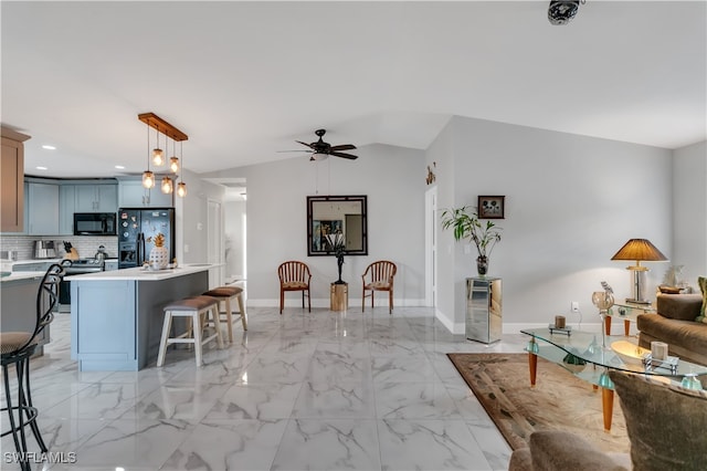 living room with ceiling fan and lofted ceiling