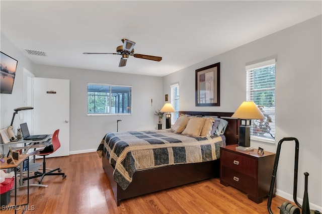 bedroom with ceiling fan and wood-type flooring