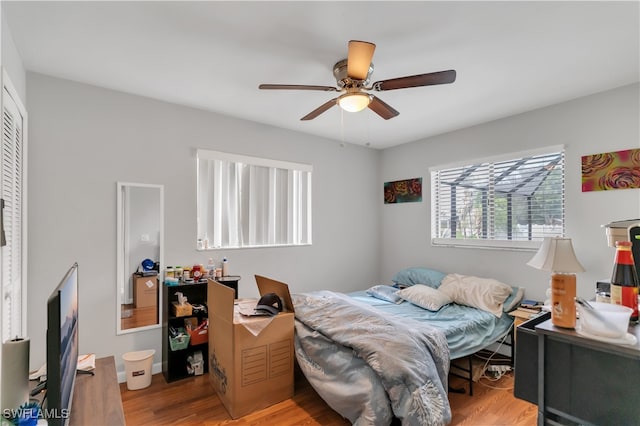 bedroom with ceiling fan and light hardwood / wood-style floors