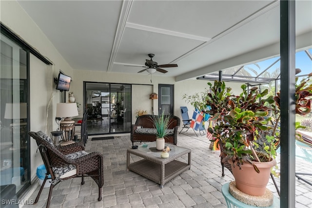 view of patio featuring ceiling fan and a lanai