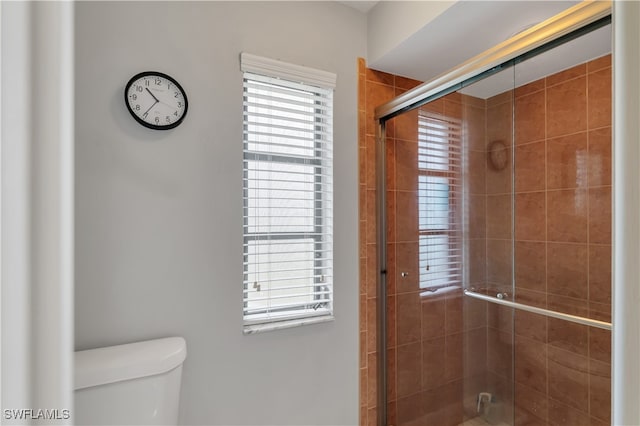 bathroom featuring toilet and walk in shower