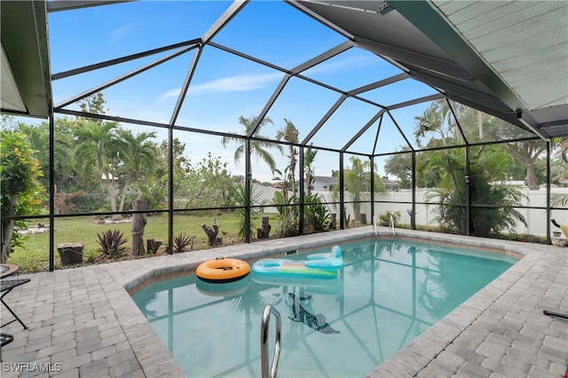 view of pool with glass enclosure and a patio