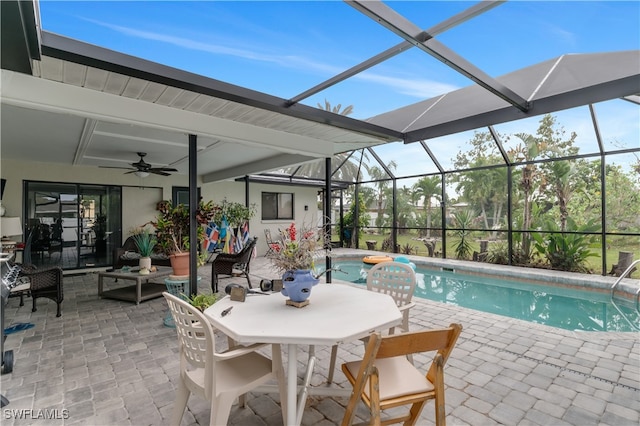 view of pool with a lanai, a patio area, ceiling fan, and outdoor lounge area