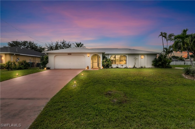 single story home with a yard and a garage