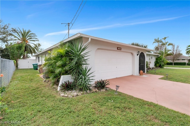 view of front of property featuring a garage and a front lawn