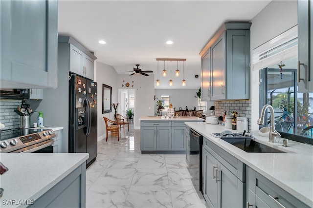 kitchen featuring pendant lighting, backsplash, black appliances, sink, and ceiling fan