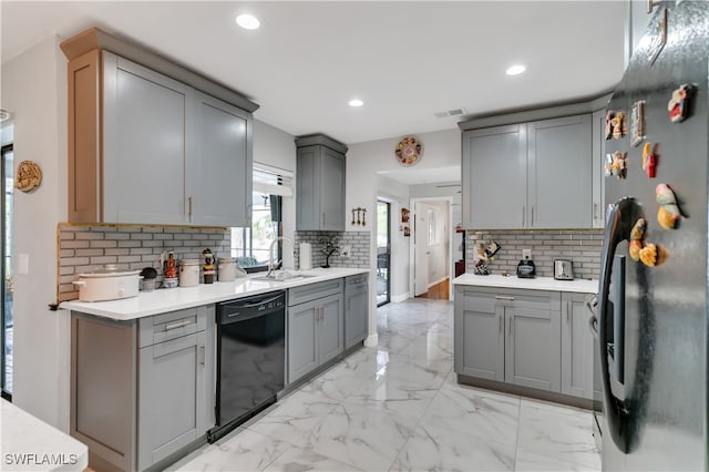 kitchen with stainless steel fridge, black dishwasher, gray cabinetry, and sink