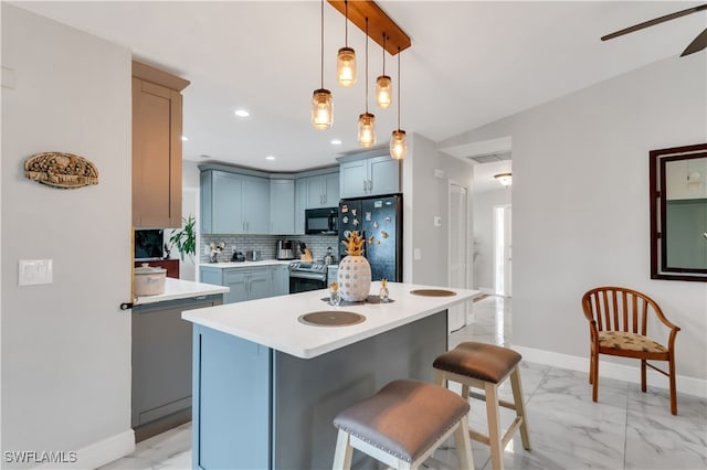 kitchen with a kitchen bar, refrigerator, decorative light fixtures, a center island, and stainless steel electric range oven