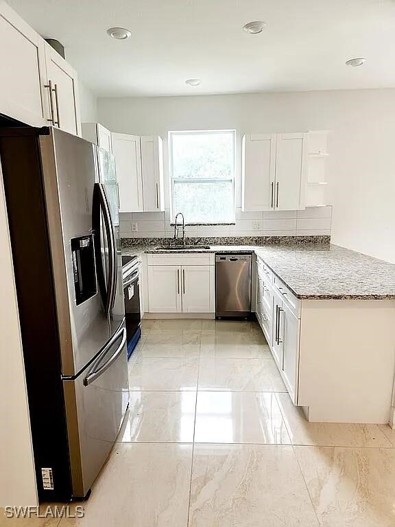 kitchen featuring white cabinetry, appliances with stainless steel finishes, and sink