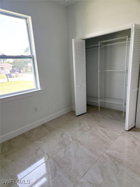 unfurnished bedroom with a closet