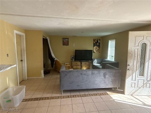 unfurnished living room with light tile patterned floors