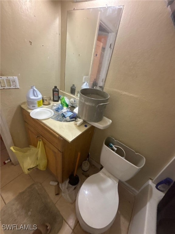 bathroom featuring toilet, vanity, and tile patterned floors