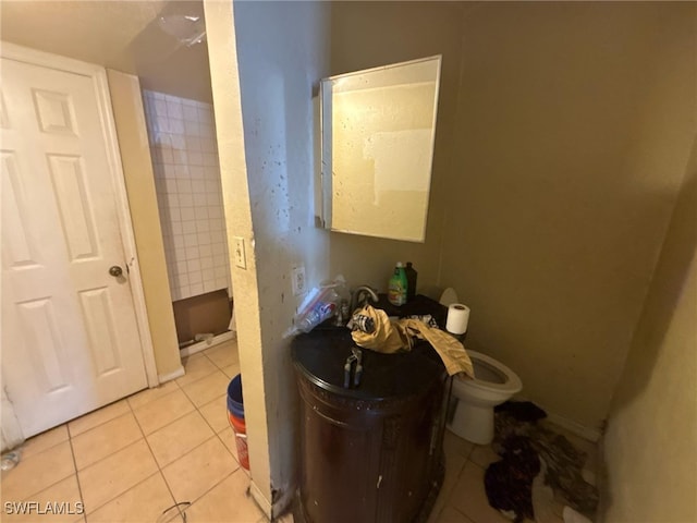 bathroom with toilet and tile patterned floors