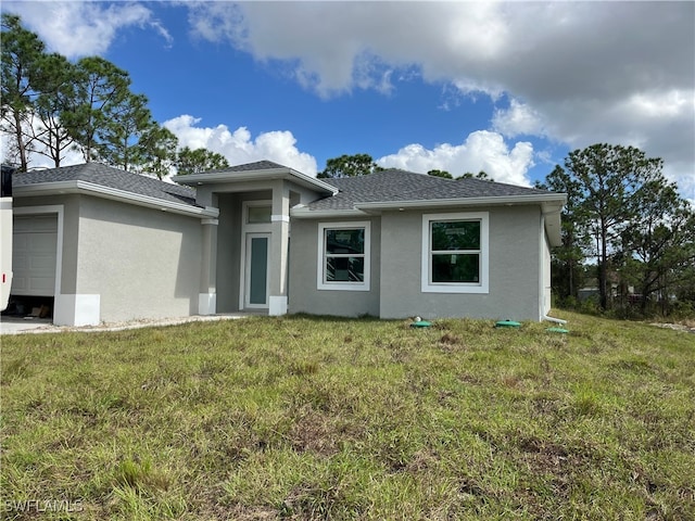 view of front of property featuring a garage and a front lawn