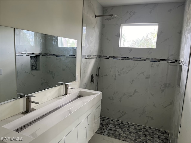 bathroom featuring vanity and tiled shower