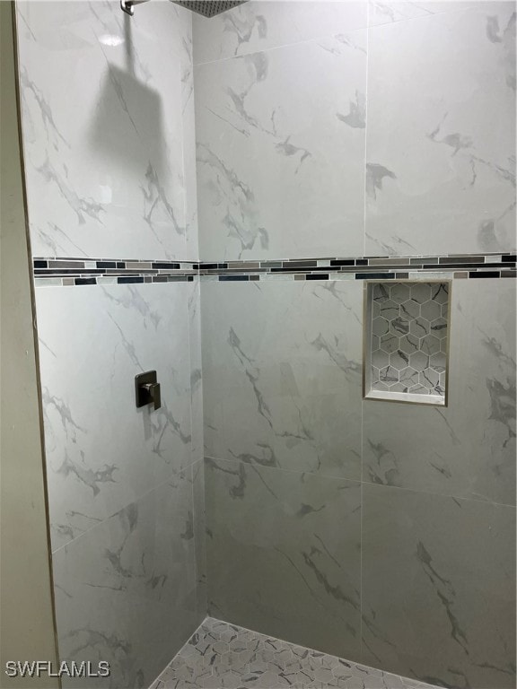 bathroom with a tile shower