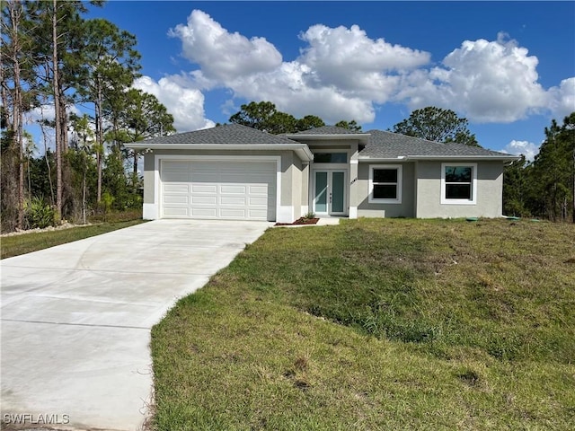 view of front of home featuring a garage, french doors, and a front lawn