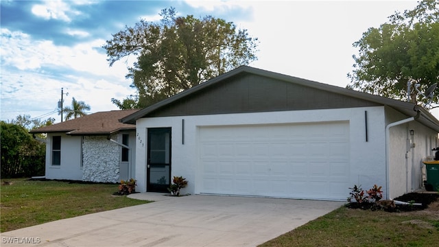 single story home featuring a garage and a front yard