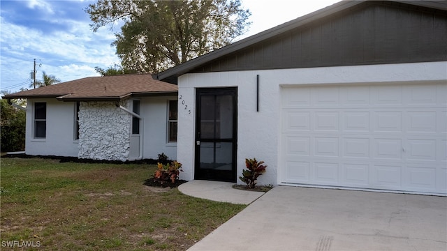 single story home featuring a front yard and a garage