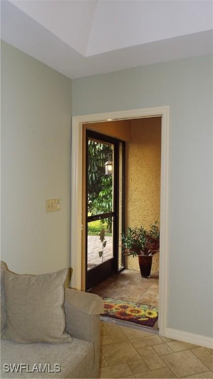 doorway to outside with tile patterned floors