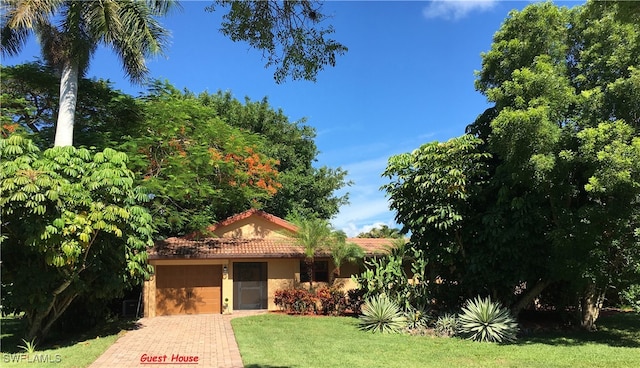 view of front of property with a front lawn and a garage