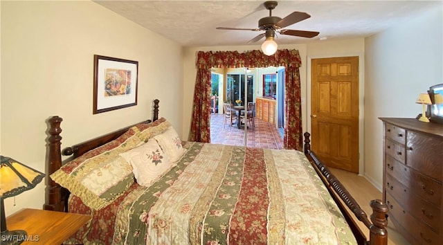 bedroom featuring ceiling fan, wood-type flooring, and a textured ceiling