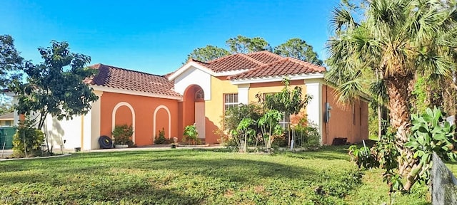 mediterranean / spanish-style home with a front lawn