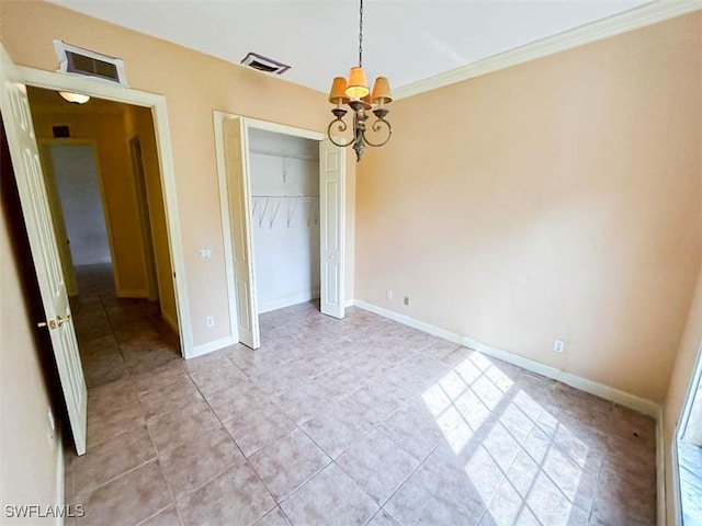 unfurnished bedroom featuring a chandelier, light tile patterned floors, a closet, baseboards, and crown molding
