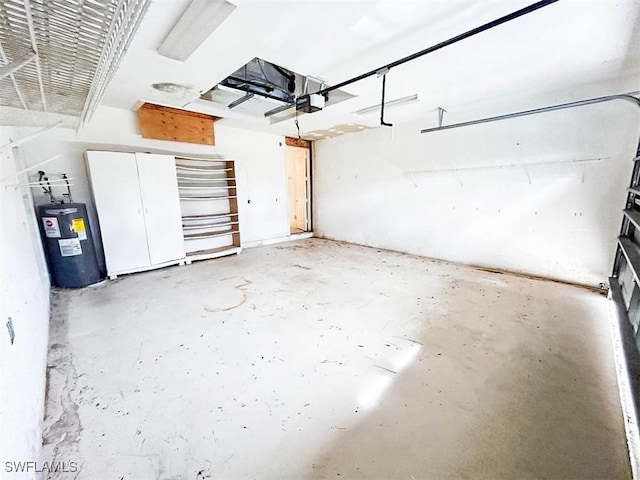 garage featuring electric water heater and a garage door opener