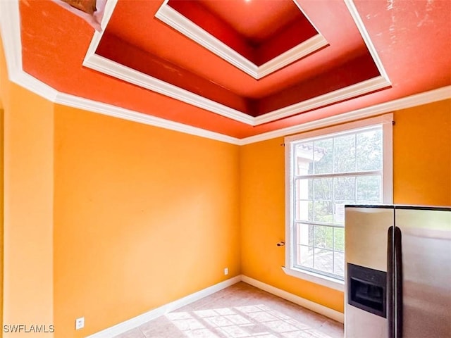 unfurnished office with a raised ceiling and ornamental molding