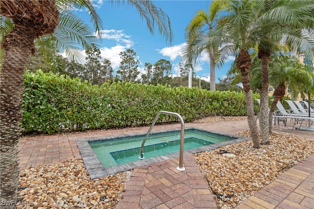 view of swimming pool featuring an in ground hot tub