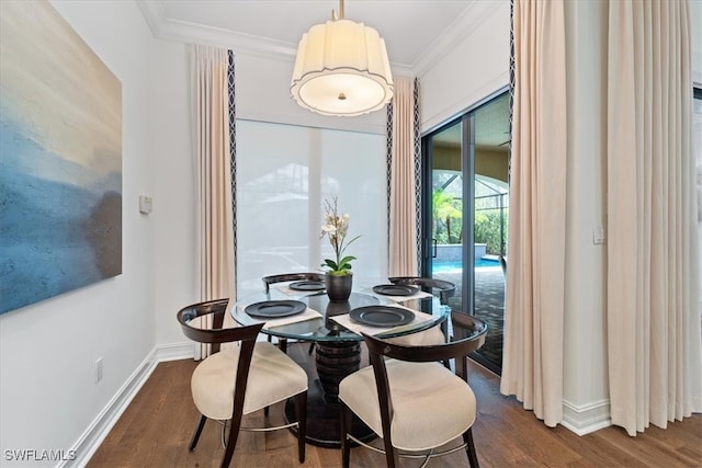 dining area featuring crown molding and hardwood / wood-style flooring