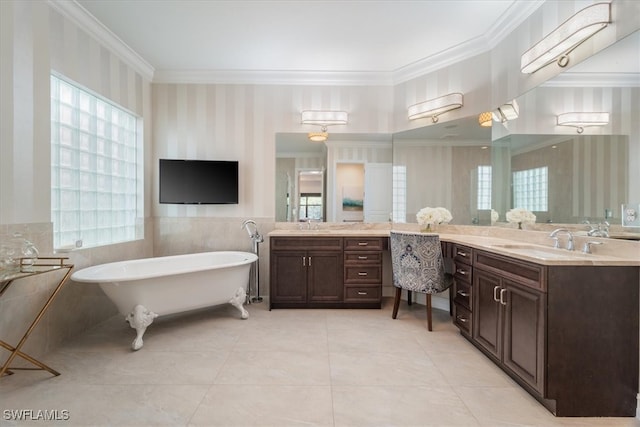 bathroom with vanity, a tub to relax in, crown molding, and tile walls