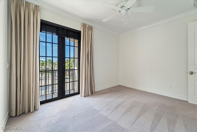 carpeted spare room with ceiling fan and ornamental molding