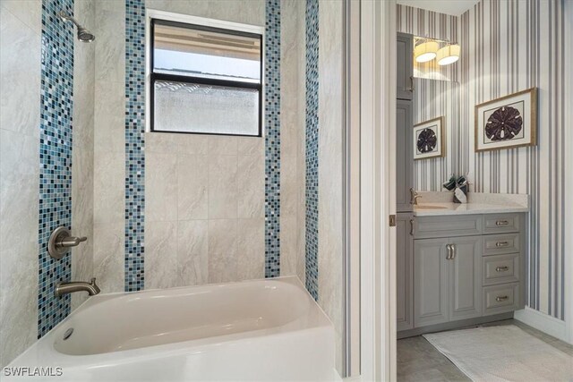 bathroom with vanity and tiled shower / bath combo