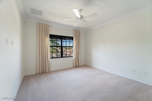 spare room featuring crown molding, ceiling fan, and light colored carpet