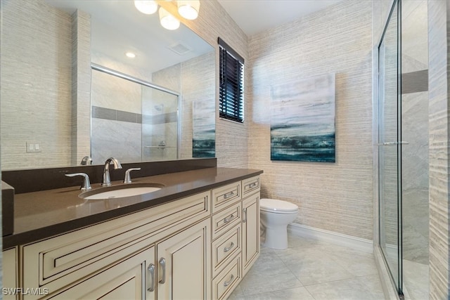 bathroom with vanity, tile patterned flooring, toilet, tile walls, and walk in shower