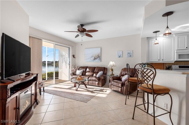 tiled living room with ceiling fan