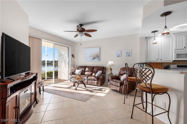 living room featuring light tile patterned floors and ceiling fan