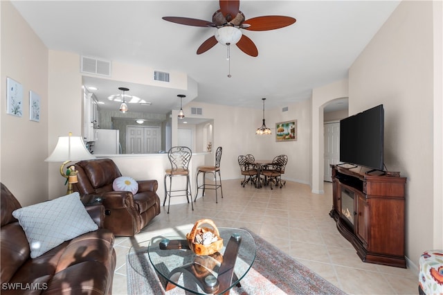 living room with ceiling fan and light tile patterned floors