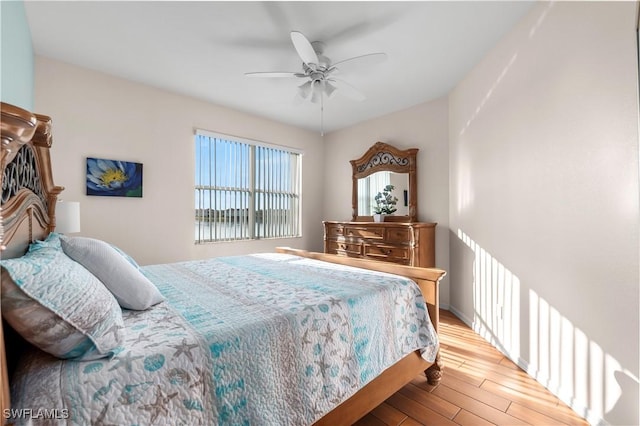 bedroom with ceiling fan and wood finished floors