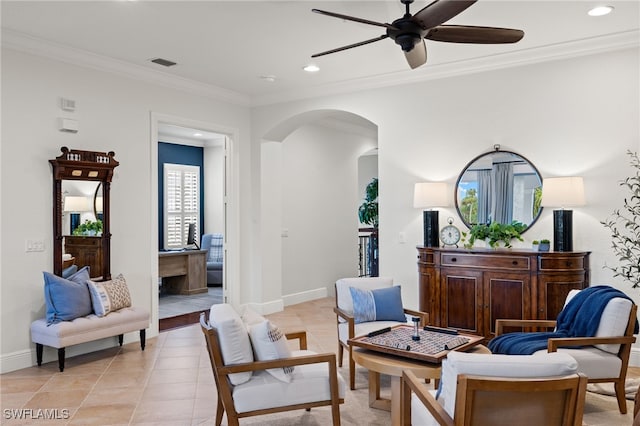 living area with ornamental molding, light tile patterned floors, and ceiling fan