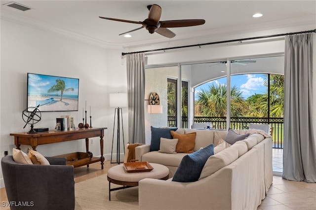 living room featuring light tile patterned floors, ornamental molding, and ceiling fan