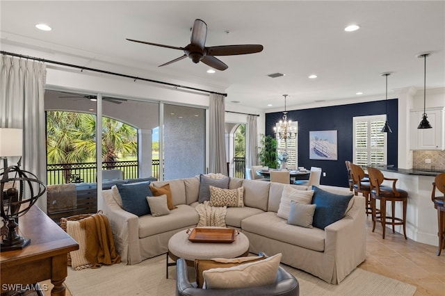 tiled living room featuring ceiling fan with notable chandelier