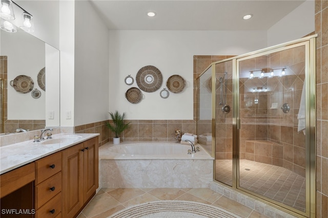 bathroom with vanity, shower with separate bathtub, and tile patterned floors